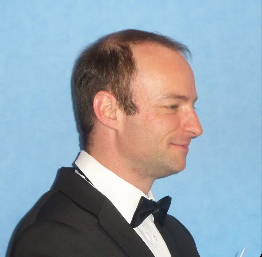 Portrait of composer Endhi Houthuijsen wearing a black tuxedo